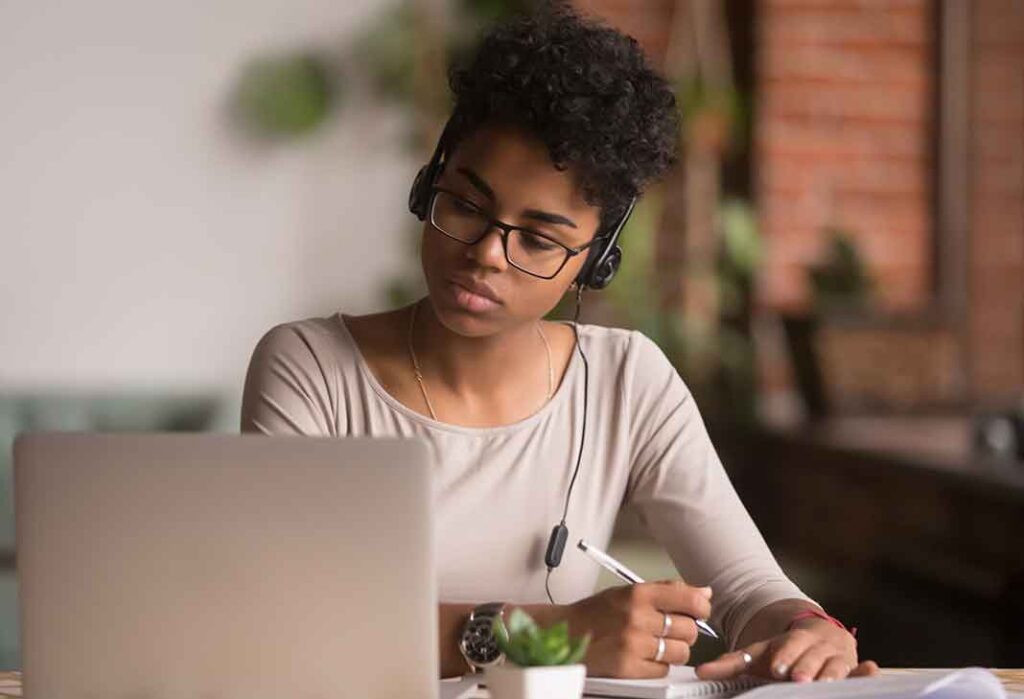 Woman with headset at laptop