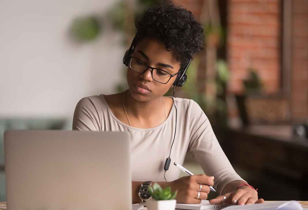 Woman with headset at laptop