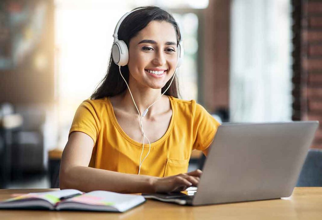 Woman with headset at a laptop